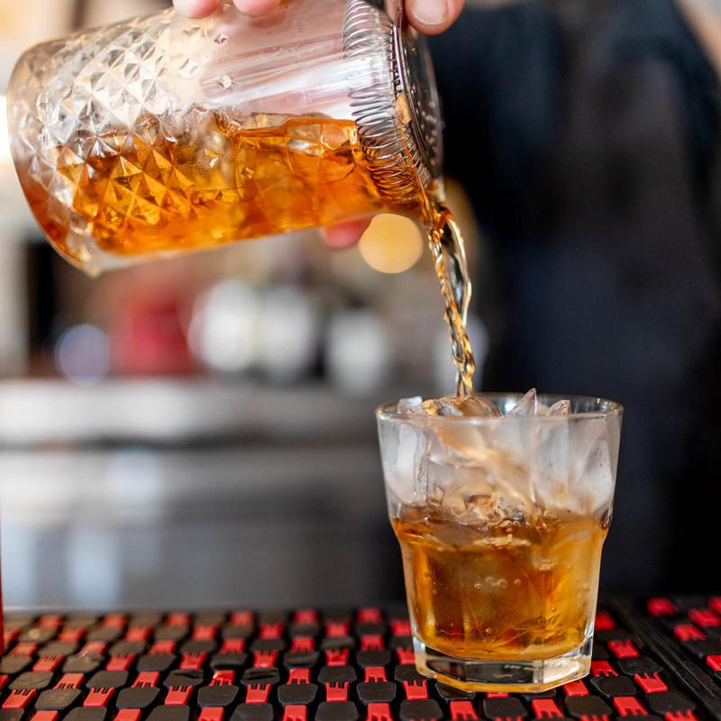 A whiskey cocktail being poured